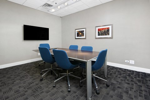 a conference room with a table and chairs